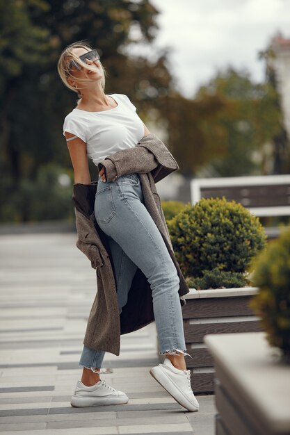 Woman with shopping bags in a summer city