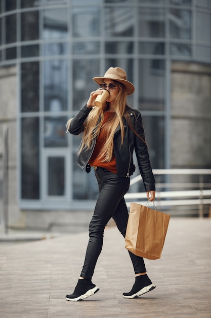 Free photo woman with shopping bags in a summer city