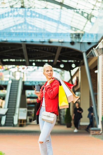 Woman with shopping packets in mall 