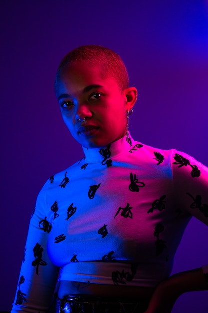 Woman with short hair covered in neon light