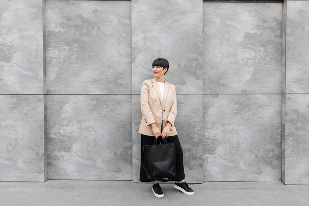 Woman with short hair holding her handbag