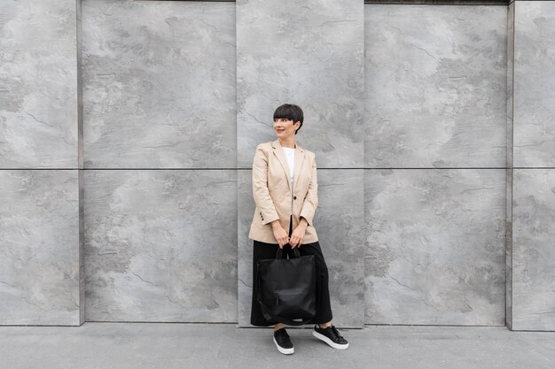 Woman with short hair holding her handbag