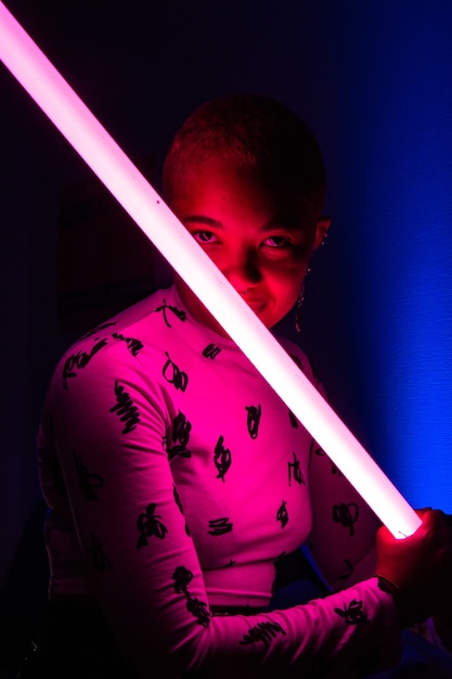 Woman with short hair holding neon light