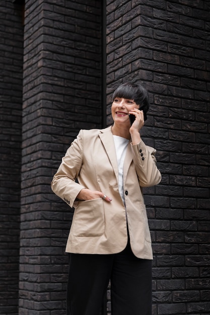 Woman with short hair talking on the phone