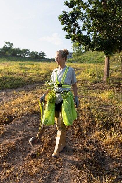 Woman with shovel on the countryside