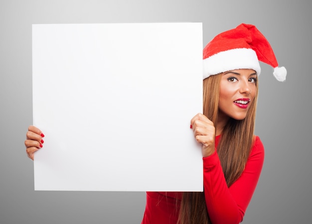 Woman with a sign in a gray background