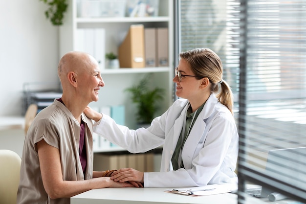 Woman with skin cancer talking with the doctor