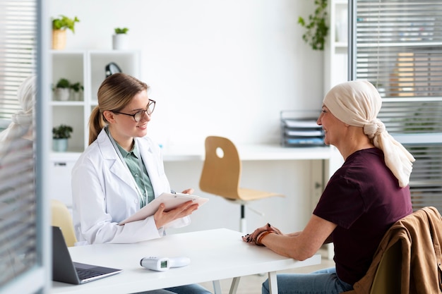 Woman with skin cancer talking with her doctor