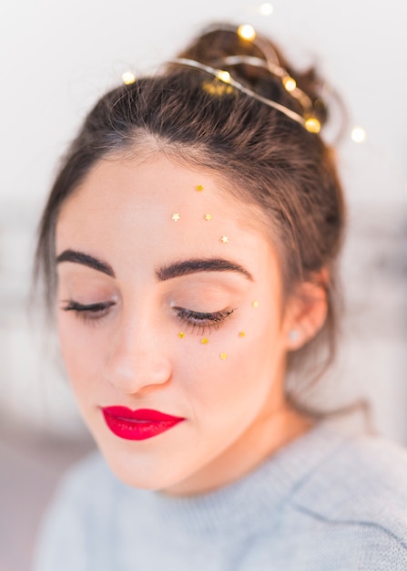 Woman with small star spangles on face