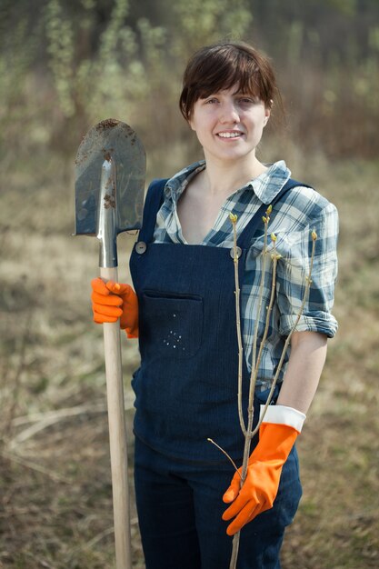 woman with spade and sprout  in spring