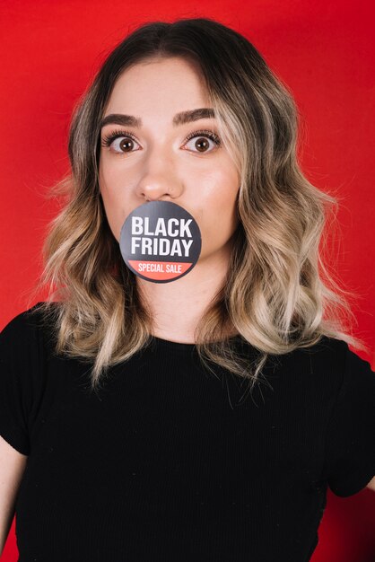 Woman with sticker on mouth for black friday 