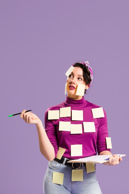 Free photo woman with sticky notes on her looking up