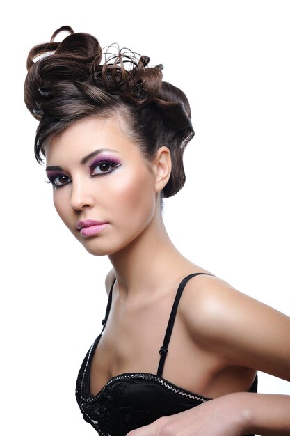 Woman with style fashion hairstyle and bright violet make-up