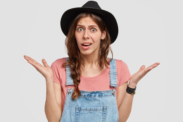 Woman with stylish black hat and overalls