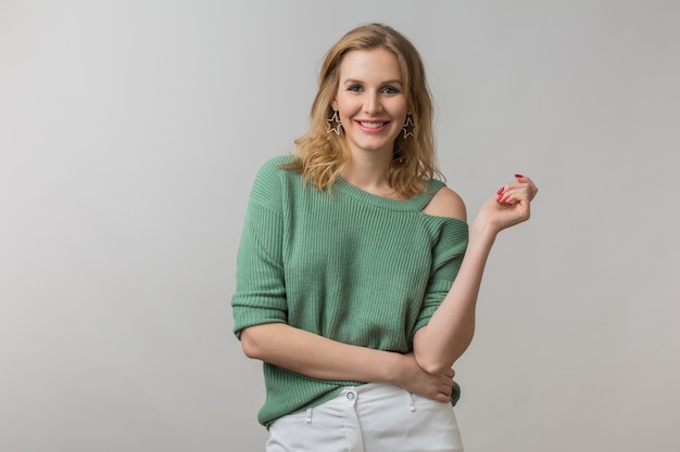 woman with stylish make-up and green sweater posing on pink