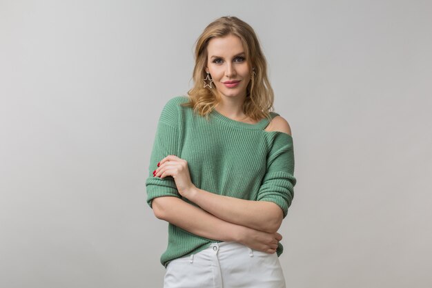 woman with stylish make-up and green sweater posing on pink