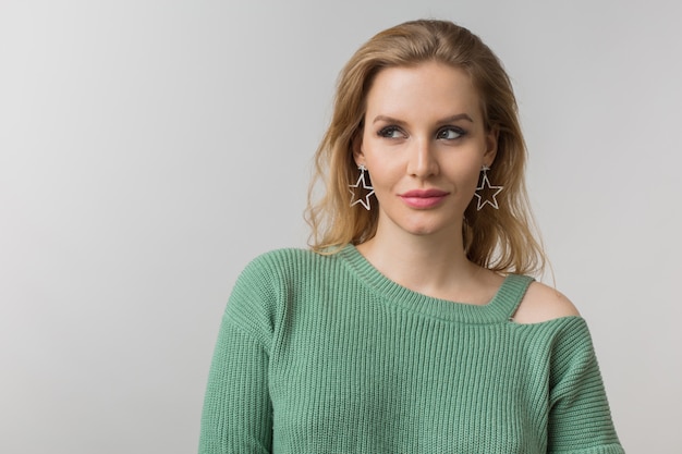 woman with stylish make-up and green sweater posing on pink