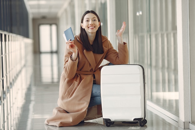 Woman with suitcase at the airport