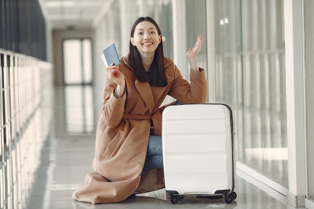 空港でスーツケースを持つ女性