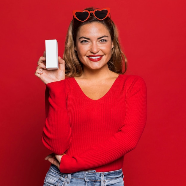 Woman with sunglasses and box medium shot