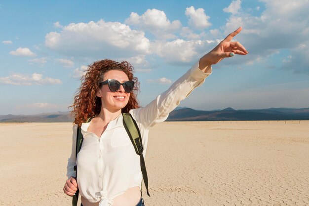 Woman with sunglasses pointing