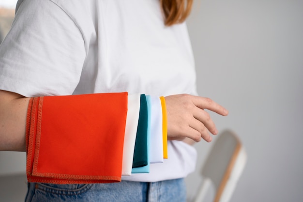 Woman with swaps of colored fabric at the colorimetry specialist