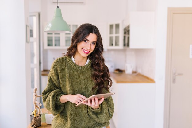 Woman with tablet looking at camera