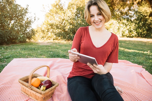 Woman with tablet looking at camera