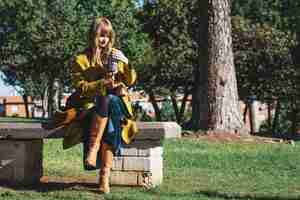 Foto gratuita donna con thermos seduto sulla panchina