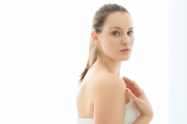 Woman with towel on body after shower