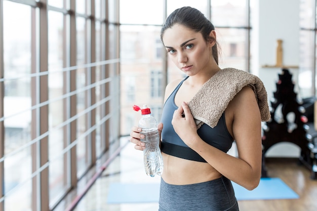 Woman with towel and bottle of water