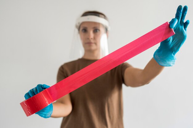 Woman with visor and tape