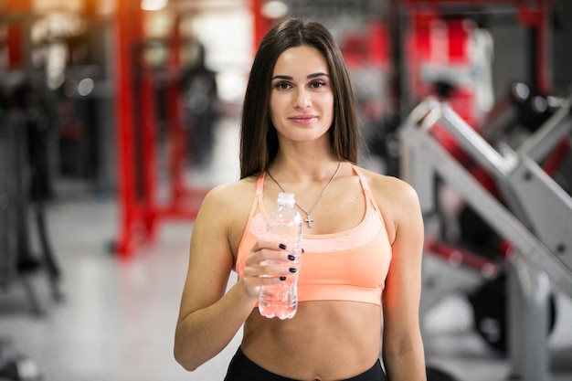 Woman with water at gym