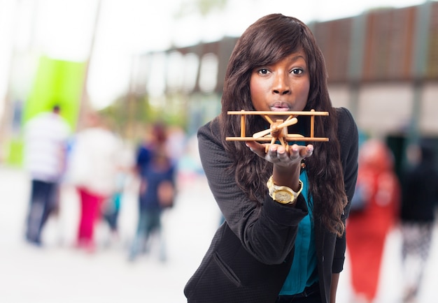 Free photo woman with a wooden plane in her hand