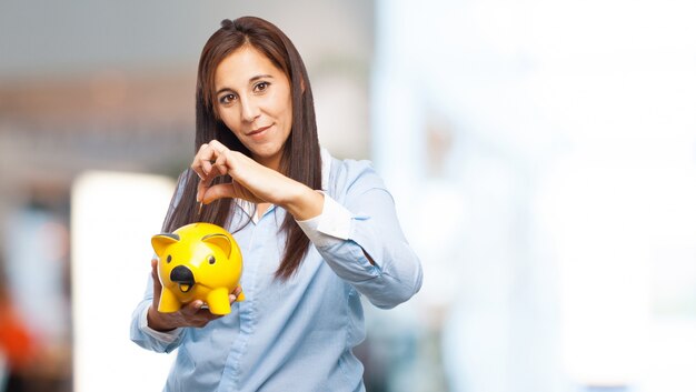 Woman with a yellow piggy bank