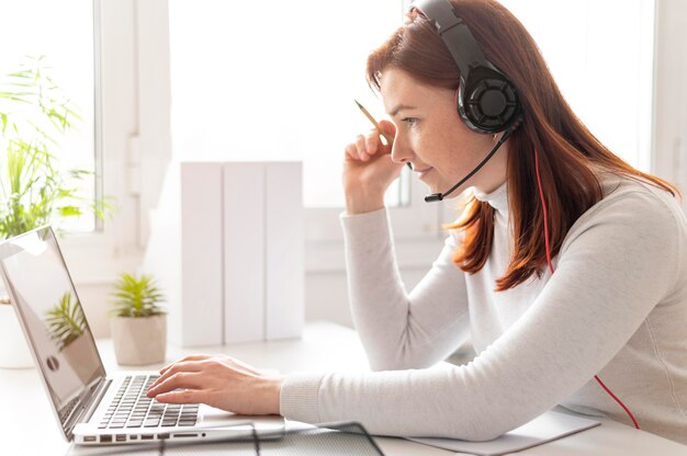 Woman at work having video call on laptop