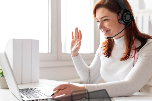woman at work having video call on laptop