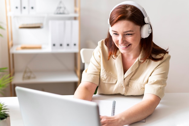 Woman at work having video call on laptop