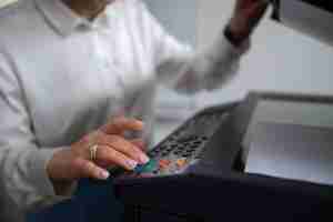 Free photo woman at work in the office using printer