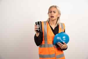 Free photo woman worker feeling lost on white background. high quality photo