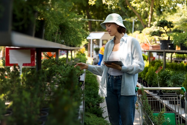 Free photo woman working alone in a sustainable greenhouse