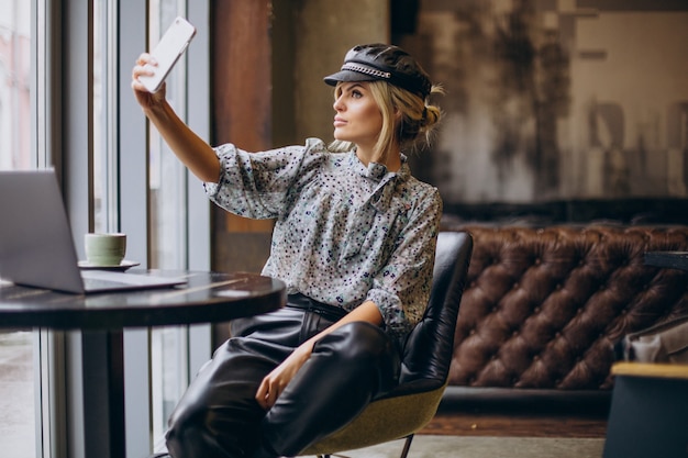 Woman working on computer and drinking coffee