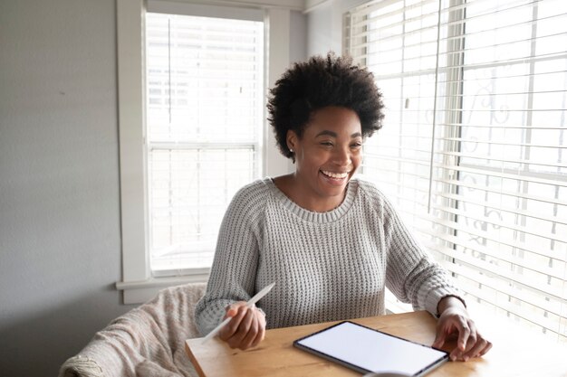 Woman working on a digital tablet in the new normal