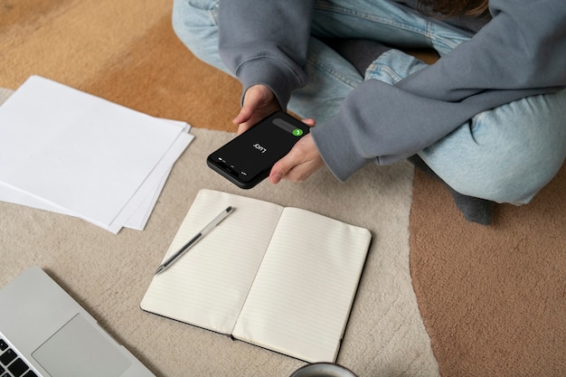 Woman working on the floor from home with device