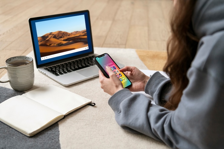 Free Photo woman working on the floor from home with device