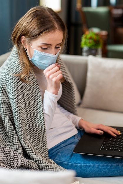 Free photo woman working from home and coughing