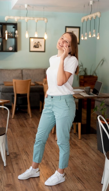 Woman working from home with smartphone during the pandemic