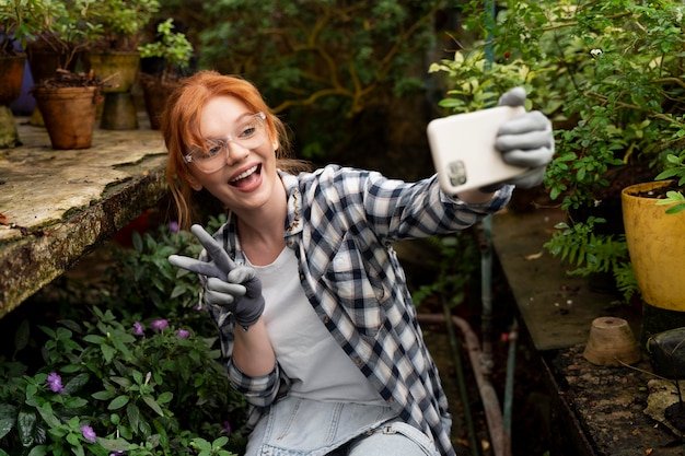 Woman working hard in a greenhouse