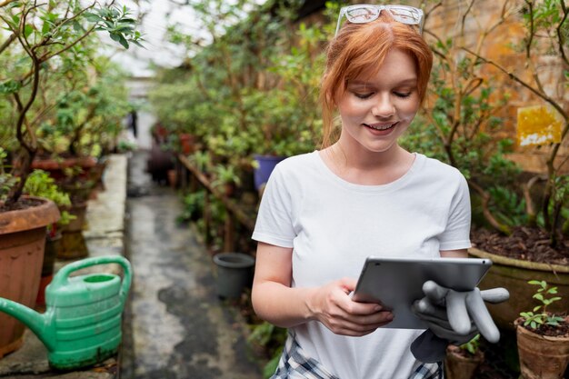 Woman working hard in a greenhouse