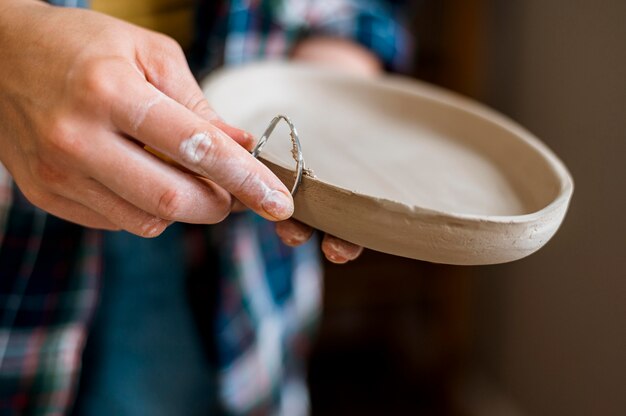 Woman working in her pottery workshop